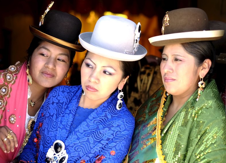 ​Aymara models look on at the fair of the Cholita garb show in Villa Esperanza.