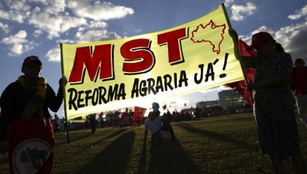 Activists hold a MST a union march in Brasilia July 11, 2013. It reads 