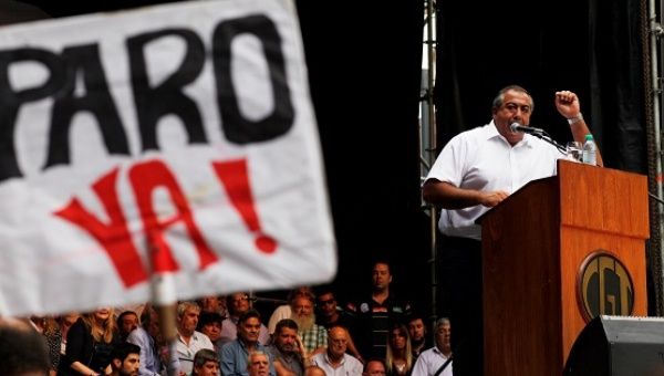 Hector Daer, secretary-general of the CGT union addresses a crowd in Buenos Aires, next to him a sign that reads 