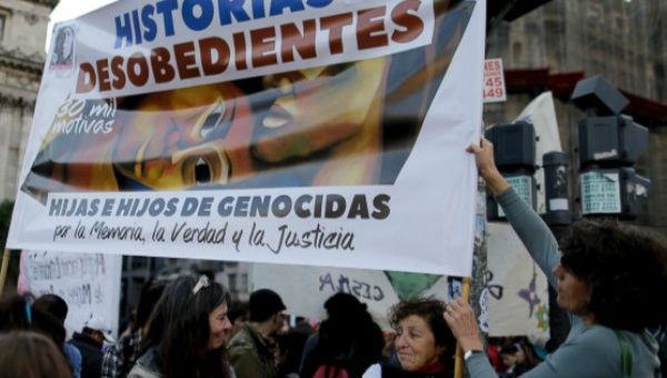 In this June 3, 2017 photo, Liliana Furio, second from right, holds a banner reading “Disobedient Stories” during a protest in Buenos Aires, Argentina.
