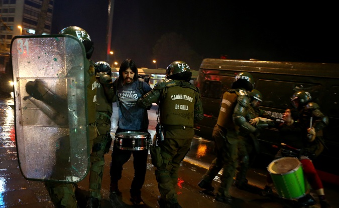 Mapuche activists are detained as they clash during a protest to demand justice for Indigenous Mapuche inmates, in Santiago, Chile September 26, 2017.