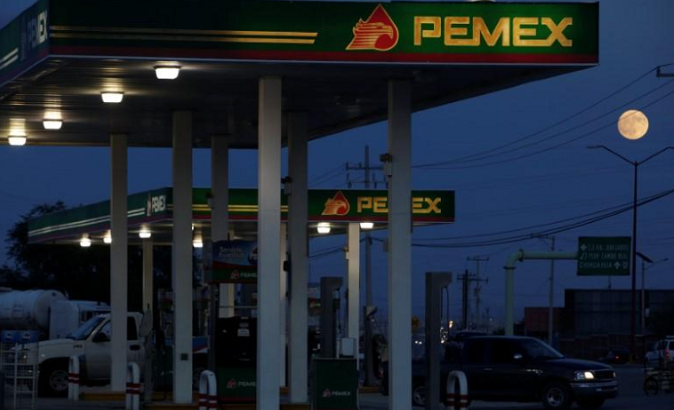 Clients get fuel at a gas station of state-owned company Petroleos Mexicanos (Pemex), in Ciudad Juarez, Mexico October 4, 2017.