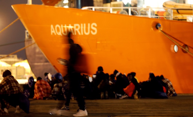 Migrants disembark from a search and rescue ship run in partnership between SOS Mediterranee and Medecins Sans Frontieres, on the island of Sicily, Italy.
