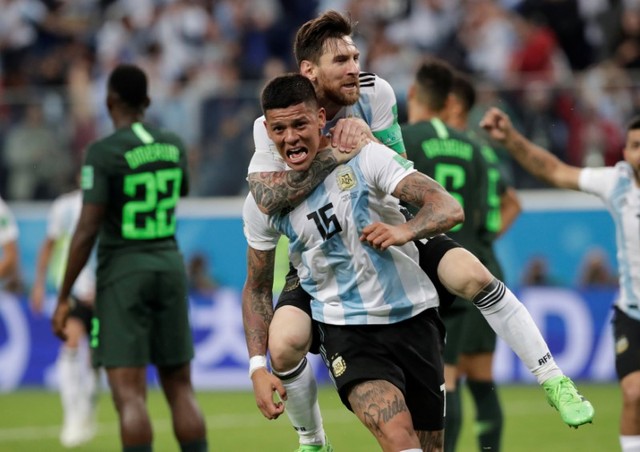 Argentina's Marcos Rojo celebrates scoring their second goal with Lionel Messi.