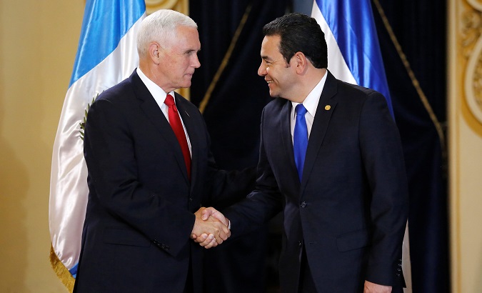 U.S. Vice President Mike Pence shakes hands President Jimmy Morales before a meeting at the National Palace of Culture in Guatemala City, Guatemala June 28, 2018.