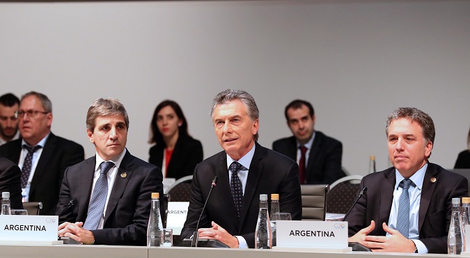 Argentine President Mauricio Macri speaks alongside Treasury Minister Nicolas Dujovne (R) and Central Bank President Luis Caputo at the G20 Meeting of Finance Ministers in Buenos Aires, Argentina, July 22, 2018