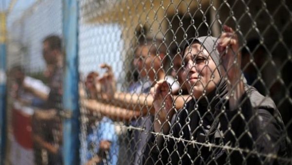 Palestinians gather in front of the gate of Rafah border crossing between Egypt and Gaza during a protest against the blockade calling for reopening of the crossing.