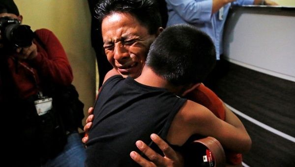 Estanislao Perez hugs his son Keidin after they were separated at the U.S. border, in Guatemala, August 7, 2018. 