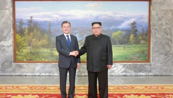 South Korean President Moon Jae-in shakes hands with North Korean leader Kim Jong Un during their summit at the truce village of Panmunjom, North Korea, on May 27, 2018. 