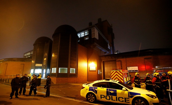 Police officers and firemen stand outside Winson Green prison, run by security firm G4S, after a serious disturbance broke out, in Birmingham, Britain, December 16, 2016.