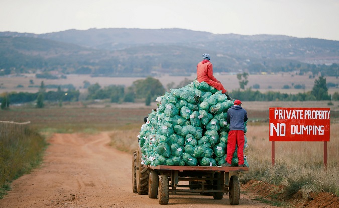 Farm workers harvest cabbages at a farm in Eikenhof, near Johannesburg, South Africa May 21, 2018.