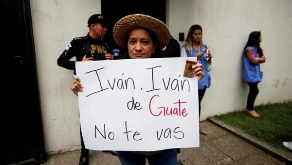 A supporter holds a sign reading 'Ivan [CICIG chief commissioner], you're not leaving Guatemala,' August 31, 2018.