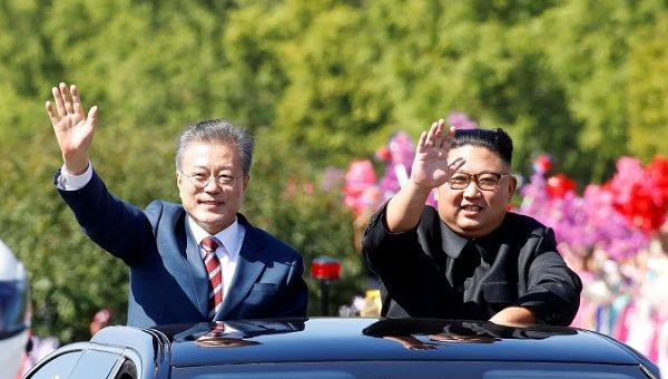 South Korean President Moon Jae-in and North Korean leader Kim Jong Un wave during a car parade in Pyongyang, North Korea, Sept. 18, 2018. 