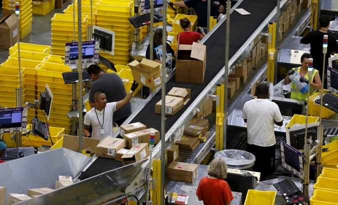 Workers sort products arriving at an Amazon Fulfilment Center in Tracy, California Aug. 3, 2015.