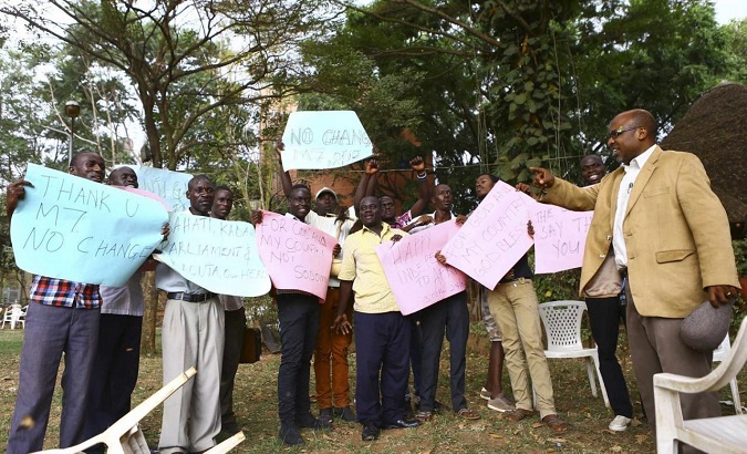 Ugandan anti-gay activist Pastor Martin Ssempa (R) celebrating after Uganda's President Museveni signed a law penalizing homosexuality in Kampala Feb. 24, 2014.