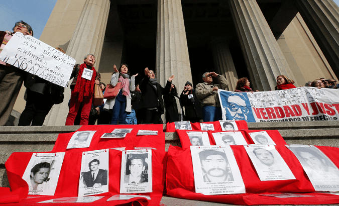 Human rights activists protest against a ruling granting parole to agents of the Chilean dictatorship on Aug. 1.