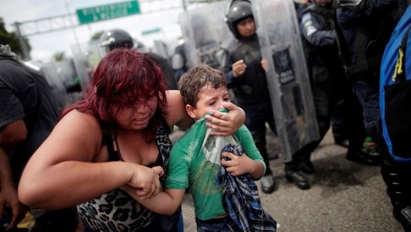 A Honduran migrant, part of a caravan trying to reach the U.S., protects her child