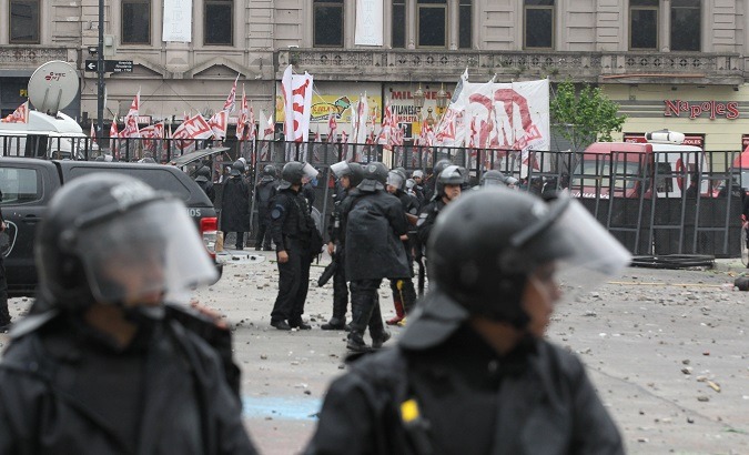 Police block protesters from nearing the national house of representatives during budget protests in Buenos Aires Wednesday