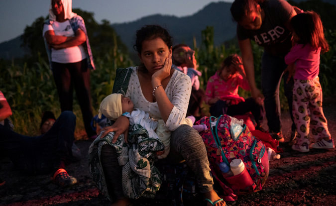 A migrant woman rests with her child while traveling from Central America to the U.S. as they make their way to Mapastepec from Huixtla, Mexico Oct. 24, 2018