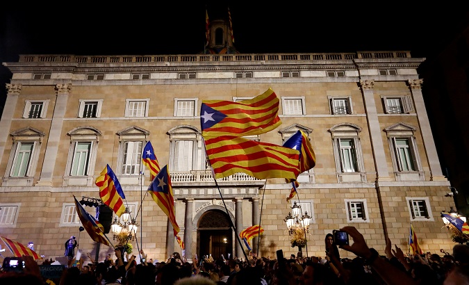 People celebrate and wave Catalan separatist flags in front of the Catalan regional government headquarters after the Catalan regional parliament declared independence from Spain in Barcelona, Spain, October 27, 2017.