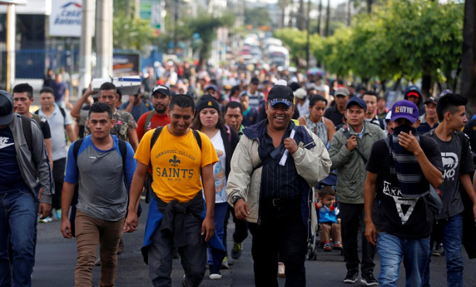 People walk in a caravan of migrants departing from El Salvador en route to the United States, in San Salvador, El Salvador, October 28, 2018.