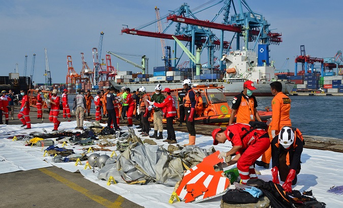 Rescue team members arrange Lion Air flight JT610 wreckage at Tanjung Priok port in Jakarta.