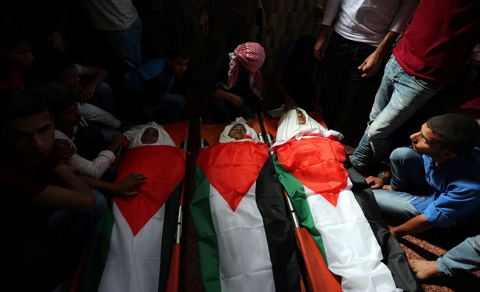 Mourners gather around the bodies of Palestinian boys who were killed in an Israeli air strike on the Gaza Strip frontier, during their funeral in the central Gaza Strip Oct. 29, 2018.