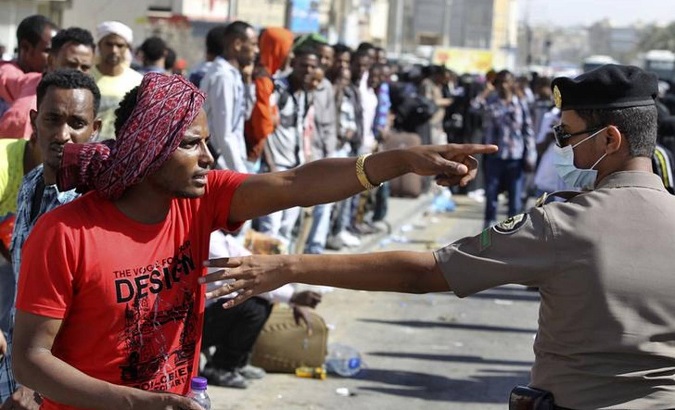 An Ethiopian worker argues with a Saudi security officer in Riyadh, where thousands of African workers gathered seeking repatriation after two people were killed in riots following a Saudi visa crackdown.