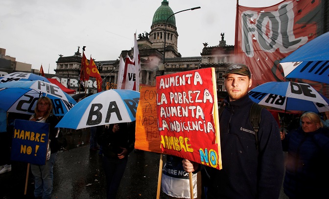 Demonstrators protest the budget bill outside the Congress in Buenos Aires, Argentina, October 24, 2018. The sign reads: 