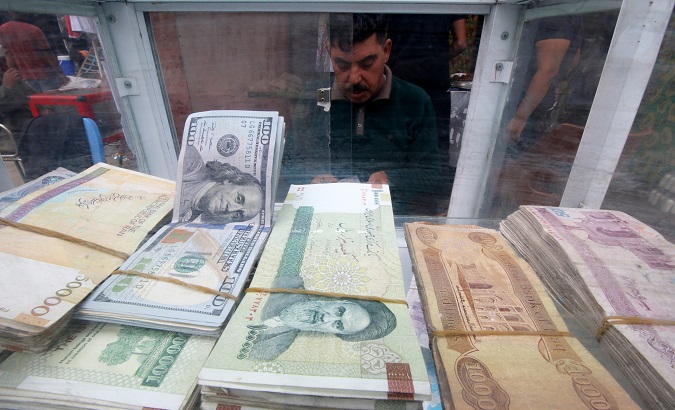 A man counts Iranian rials at a currency exchange shop, before the start of the U.S. sanctions on Tehran, in Basra, Iraq Nov. 3, 2018.
