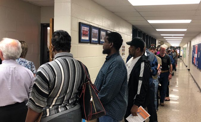 Voters waiting in line in Georgia due to faulty voting machines.