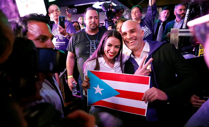 Newly elected Congresswoman Alexandria Ocasio-Cortez holds a Puerto Rican flag as she greets supporters at her midterm election night party in New York City, United States.