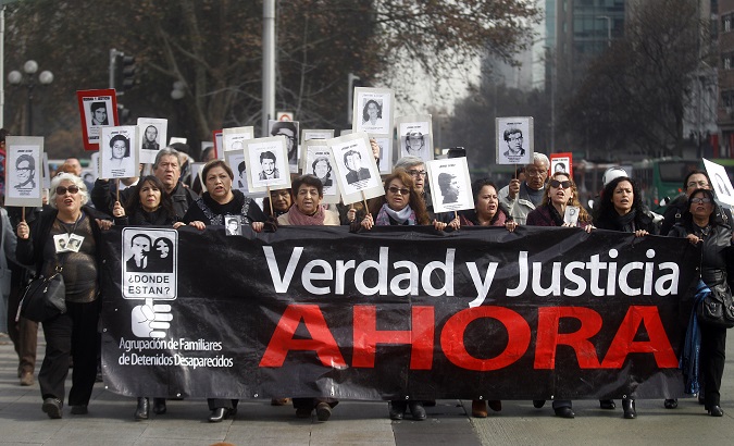 Activists in Chile marched against pardoning human rights abusers from Pinochet's regime this July.