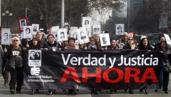 Activists in Chile marched against pardoning human rights abusers from Pinochet's regime this July.