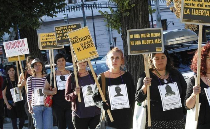 Members of feminist organizations in Chile hold signs during a rally against gender violence. Argentina sufferes one of Latin America's highest femicide rates. December 26, 2014.