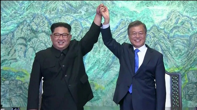 South Korean President Moon Jae-in and North Korean leader Kim Jong Un gesture after signing agreements during the inter-Korean summit.