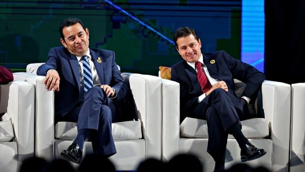 Guatemala's President Jimmy Morales and Mexico's president Enrique Peña Nieto participate in a forum during the XXVI Ibero-American Summit in Antigua Guatemala