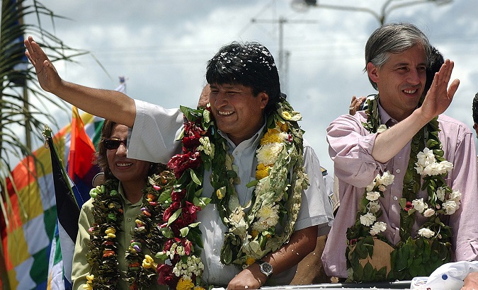 Bolivian President Evo Morales attends a parade with his Vice President Alvaro Garcia Linera.