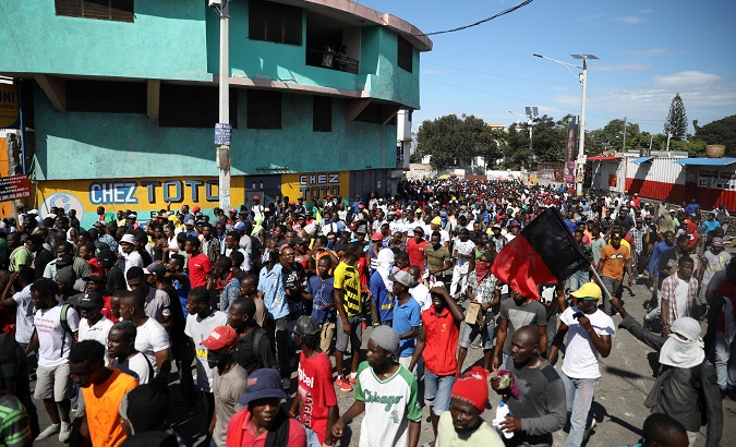 Haitians participate in anti-government protests.