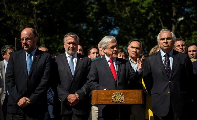 Sebastian Piñera during a press conference. To his right, Interior Minister Andres Chadwick.