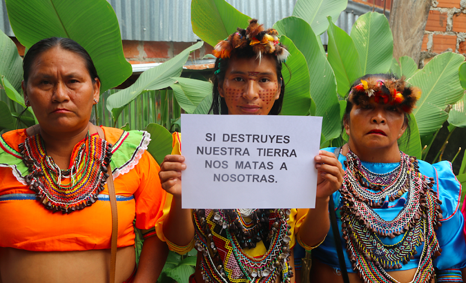 Indigenous women from Aidesep. The sign reads 