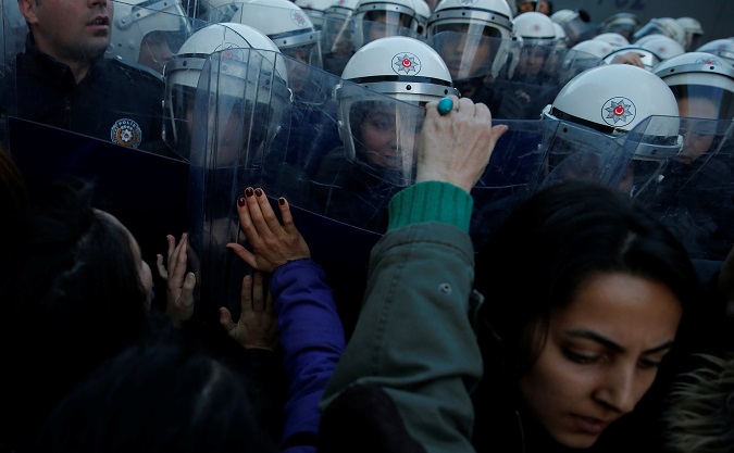 Women's rights activists are pushed by state riot police as they try to march through Taksim Square for the International Day for the Elimination of Violence Against Women in Istanbul, Turkey, November 25, 2018.