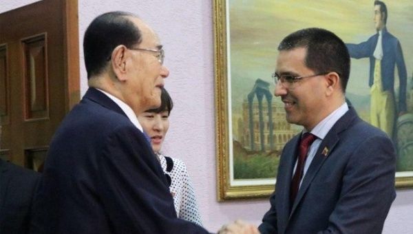 North Korea's Kim Yong-nam greets Venezuela's Jorge Arreaza.