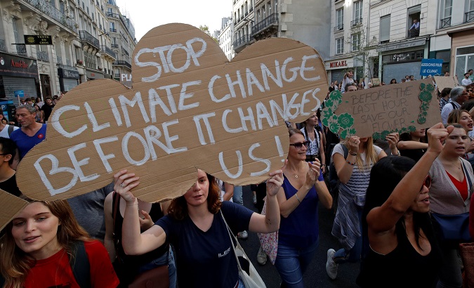 Protesters march to urge politicians to act against climate change in Paris Wednesday.