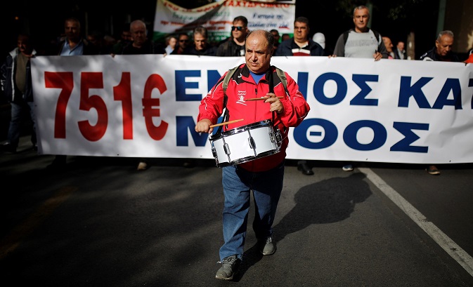 Greek workers stage a massive march in the capital of Athens to protest government cuts in pensions and wages. Media outlets across the country staged a similar strike Tuesday, Nov. 28.