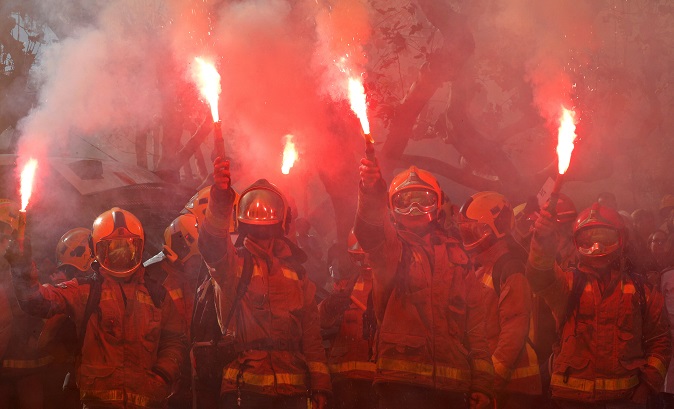 Firemen protest against cuts and working conditions in front of Catalonia Parliament in Barcelona, Spain, Nov. 28, 2018.