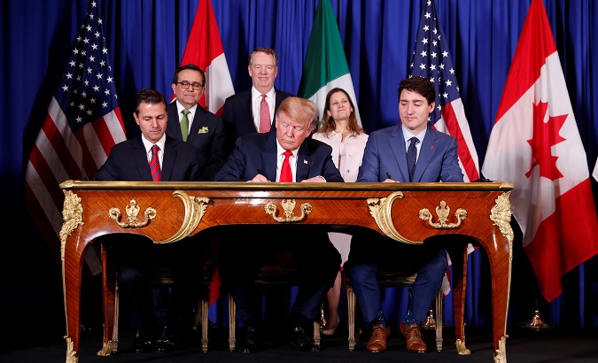 Mexico's President Enrique Peña Nieto, U.S. President Donald Trump, and Canada's Prime Minister Justin Trudeau sign USMCA before the G20 summit.