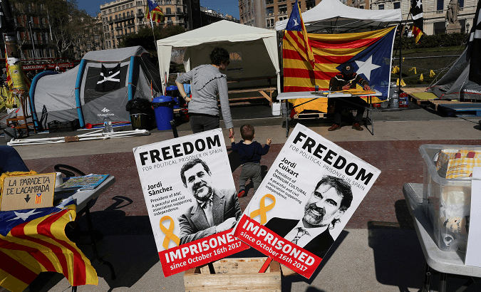 Banners with the photos of jailed Catalan pro-independence leaders Jordi Sanchez and Jordi Cuixart shown in a rally in Barcelona.