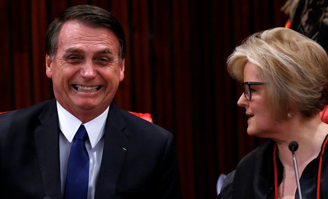 Brazil's President-elect Jair Bolsonaro reacts next to Rosa Weber, the President of the Superior Electoral Tribunal (TSE) before receiving a confirmation of his victory in the recent presidential election in Brasilia, Brazil December 10, 2018.