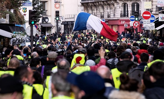 Protesters gather during a yellow vest walk in the streets next to the Opera in Paris, on Dec. 22.